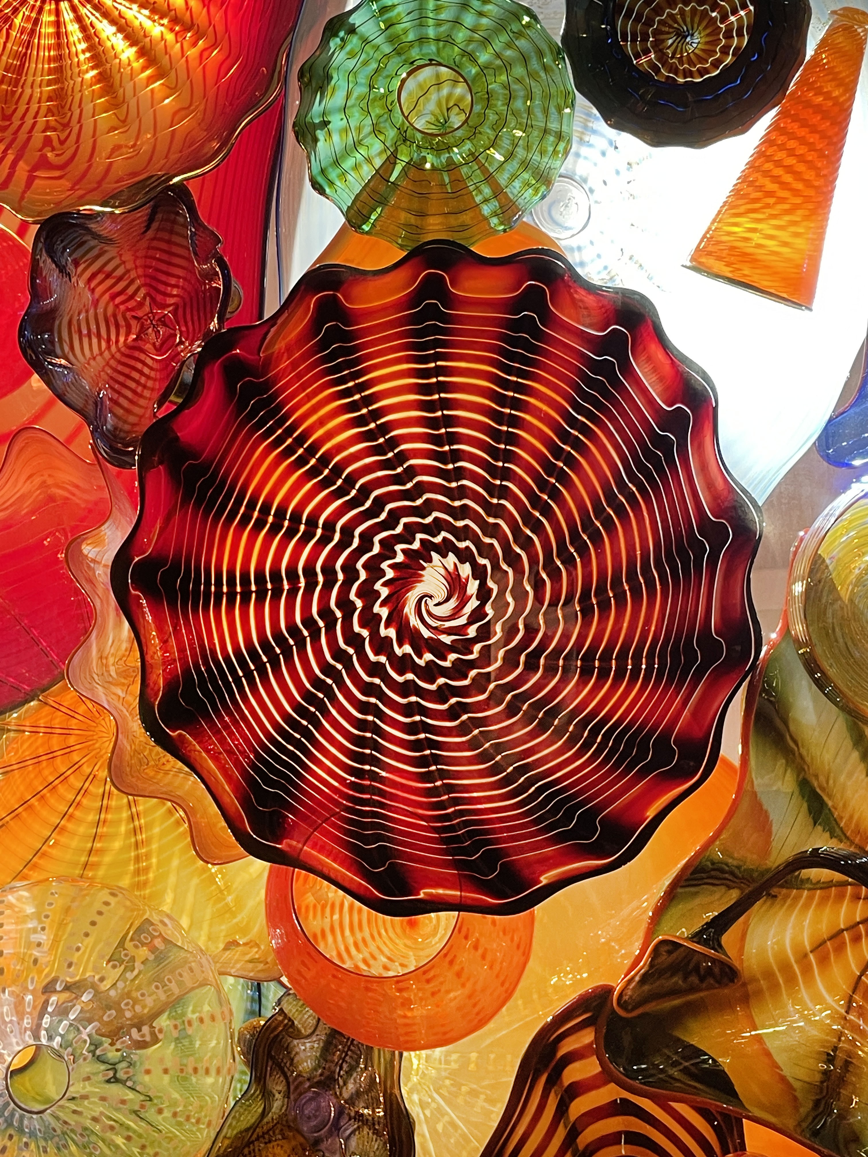 Colorful blown-glass vessels viewed from below