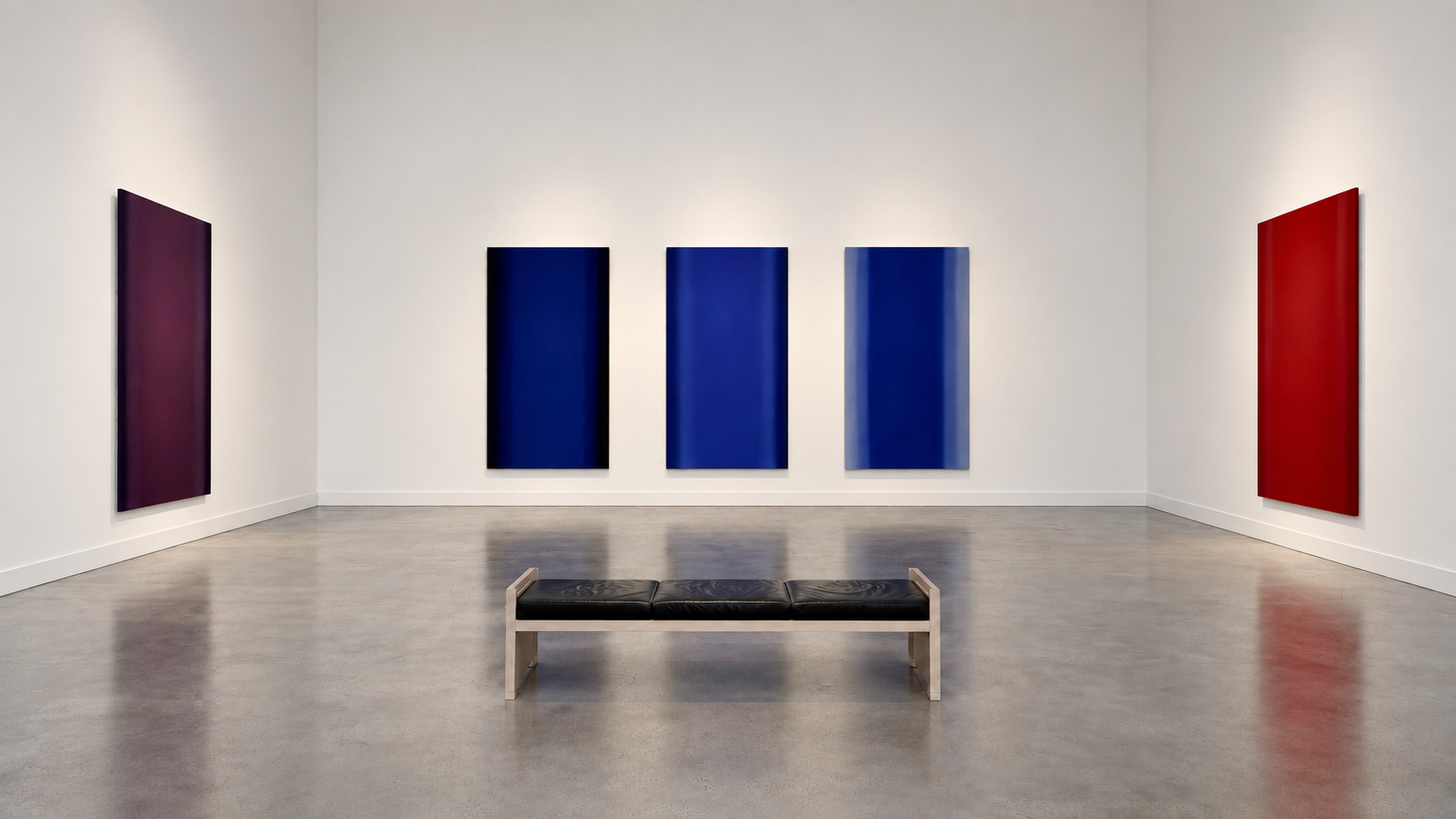 White gallery interior with color-field paintings and a bench