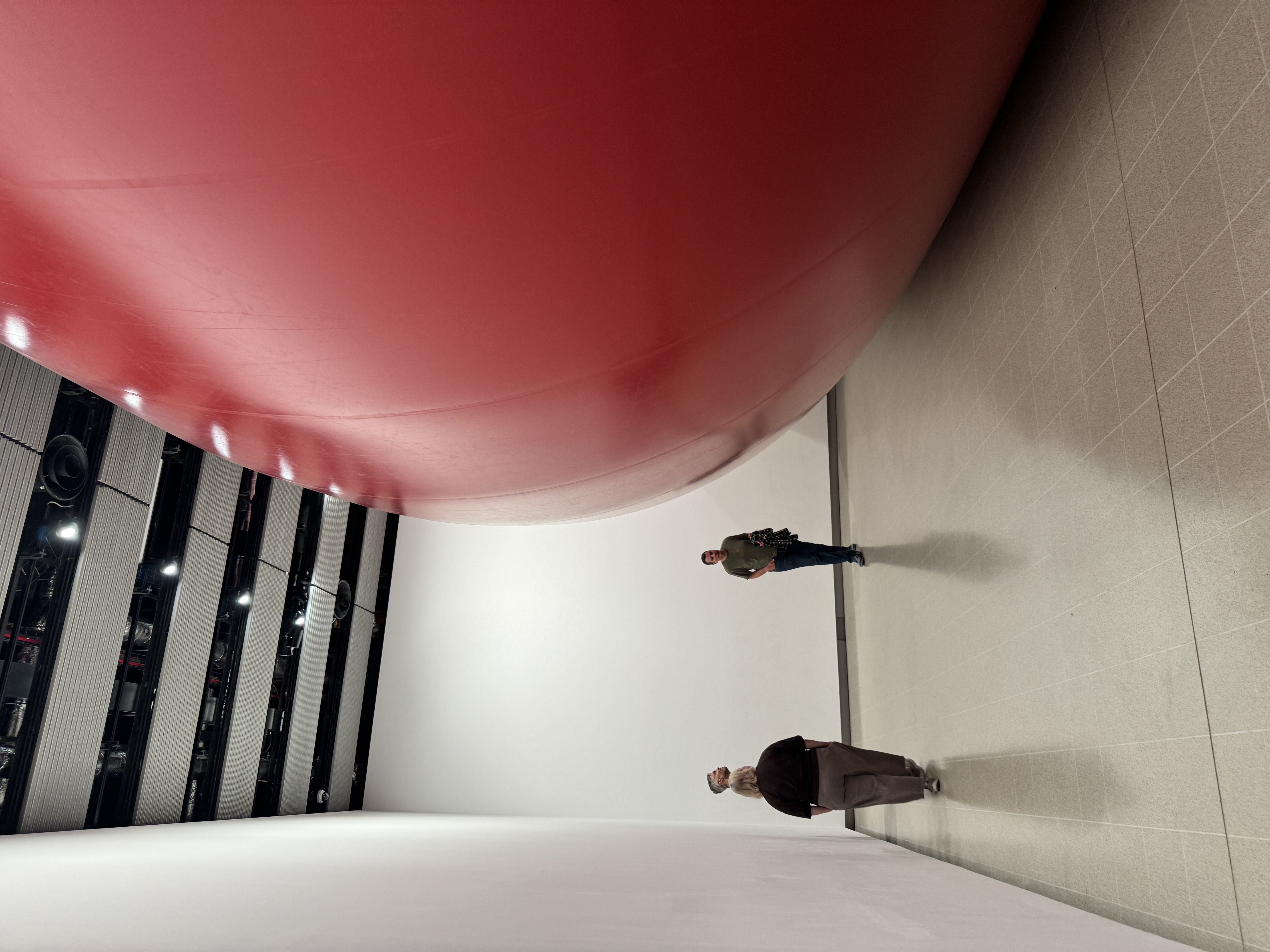 Large red Anish Kapoor sculpture filling a gallery at Hayward Gallery in London